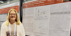 Powers-Carson next to her poster at the 2023 AACC Conference.